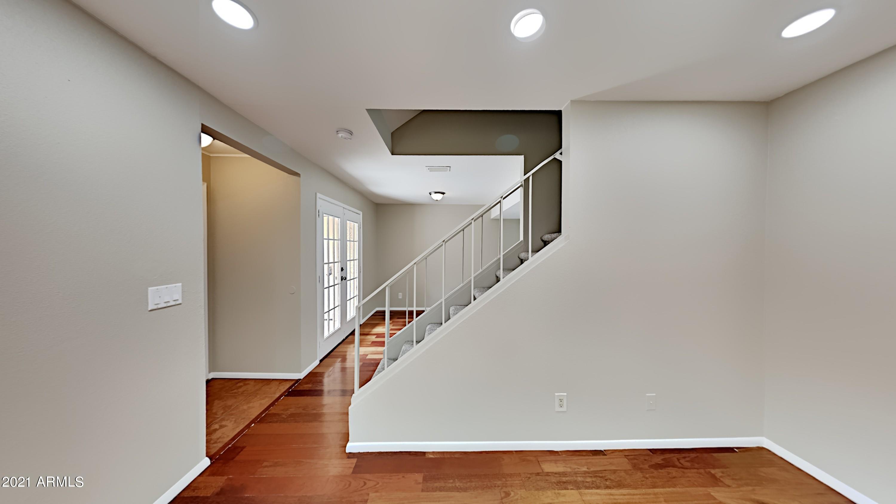 3511 East Baseline Road, Unit 1013 Phoenix, AZ 85042 - Photo 3 of 13 a view of entryway and hall with wooden floor