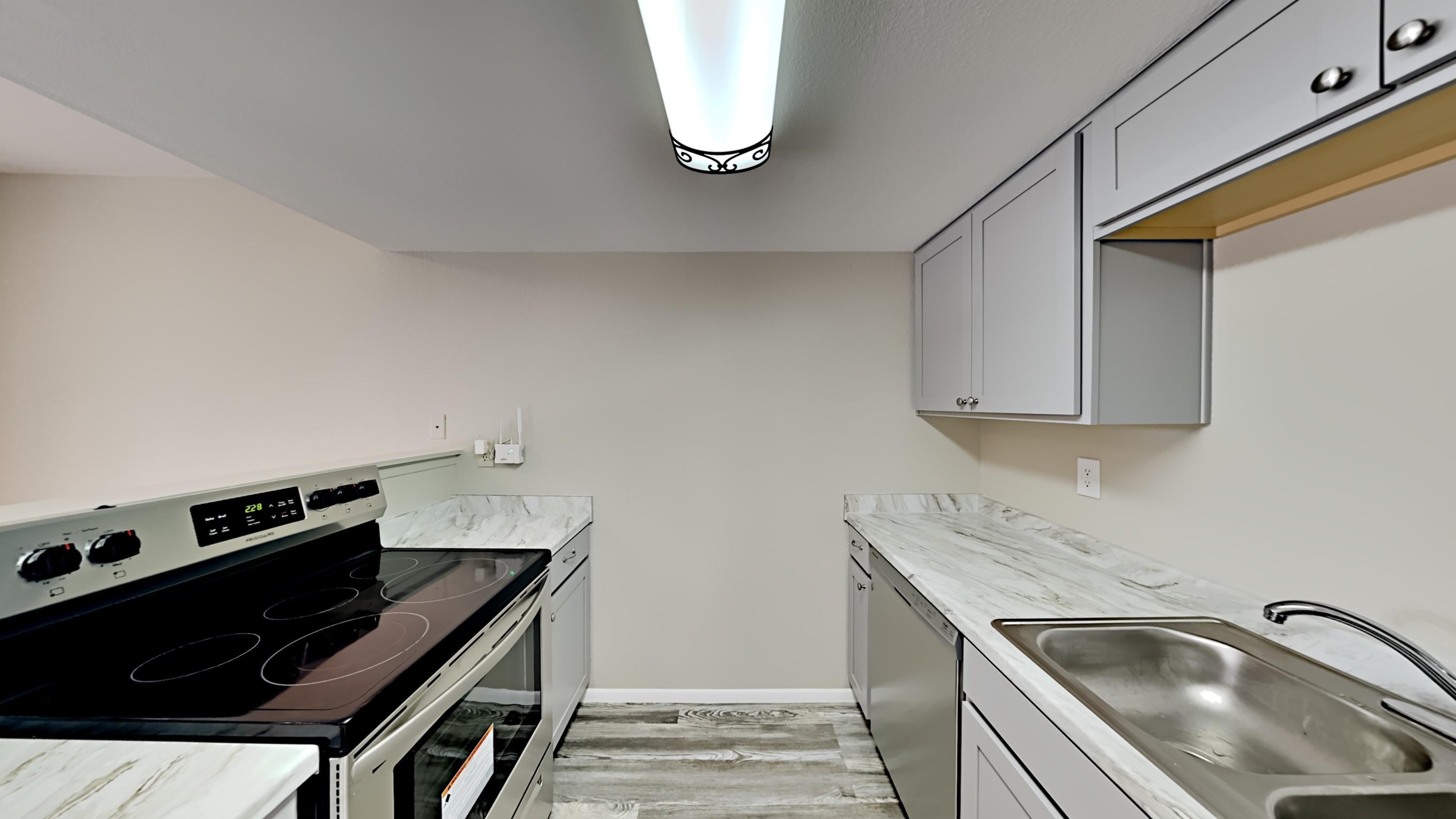 3511 East Baseline Road, Unit 1013 Phoenix, AZ 85042 - Photo 4 of 13 a kitchen that has a sink and a stove