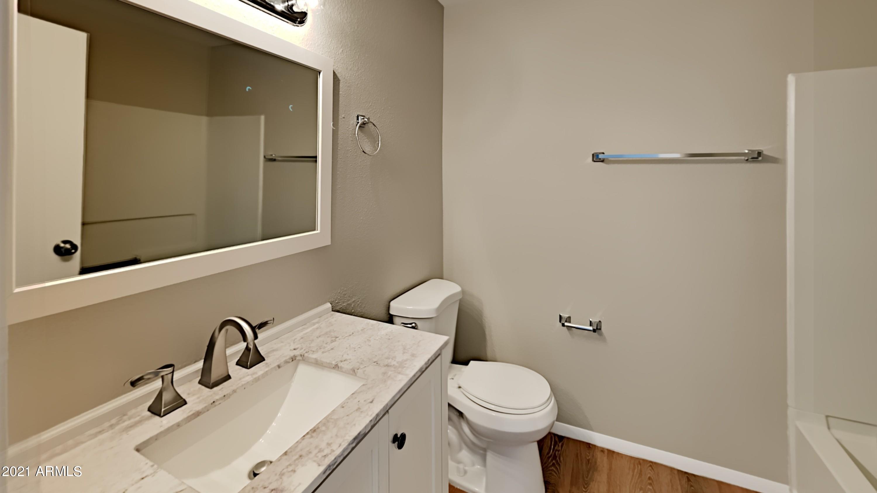 3511 East Baseline Road, Unit 1013 Phoenix, AZ 85042 - Photo 10 of 13 a bathroom with a sink and a toilet