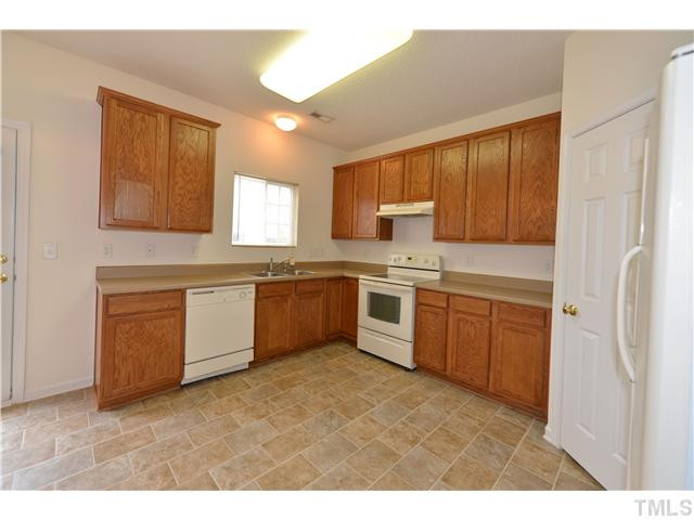 3365 Bridgeville Road Raleigh, NC 27610 - Photo 5 of 13 a kitchen with a white stove top oven sink and cabinets