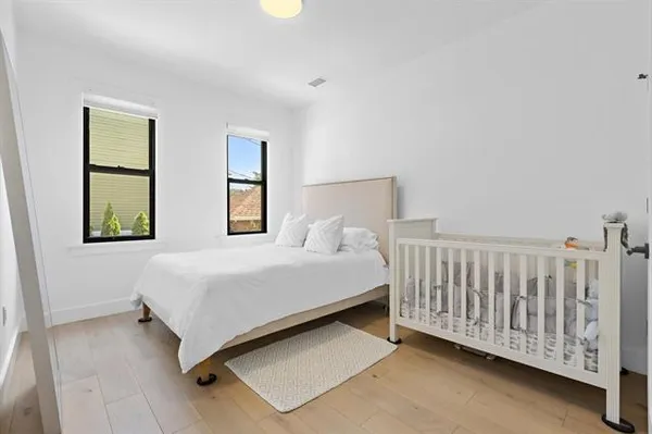 a large bed sitting in a room next to a lamp