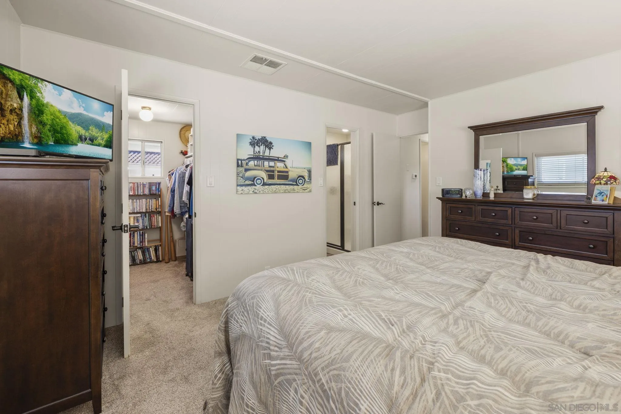 116 Havenview Lane Oceanside, CA 92056 - Photo 16 of 47 a spacious bedroom with a bed and a dresser with mirror