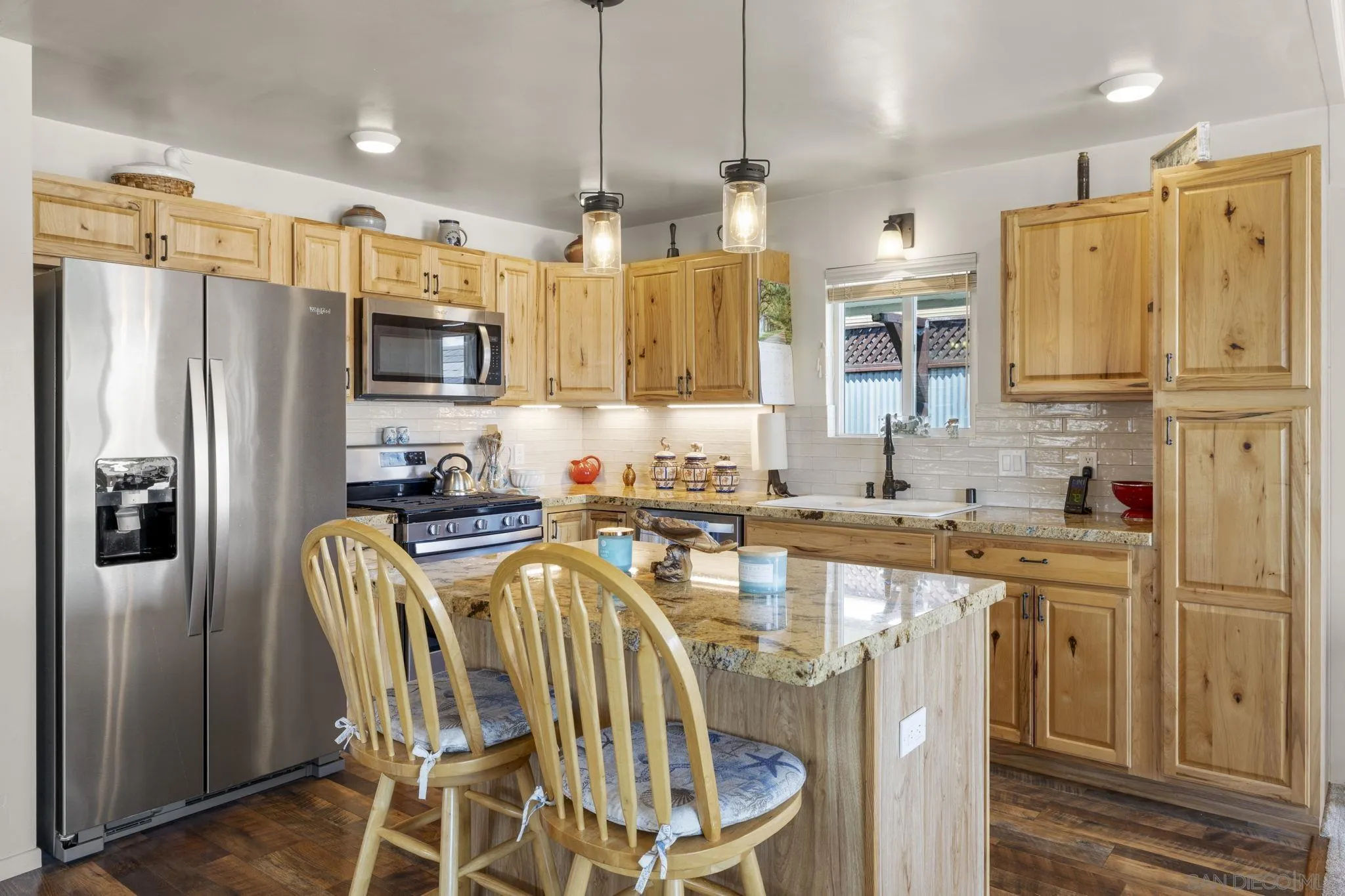 116 Havenview Lane Oceanside, CA 92056 - Photo 2 of 47 a kitchen with stainless steel appliances granite countertop a refrigerator a sink a stove a dining table and chairs