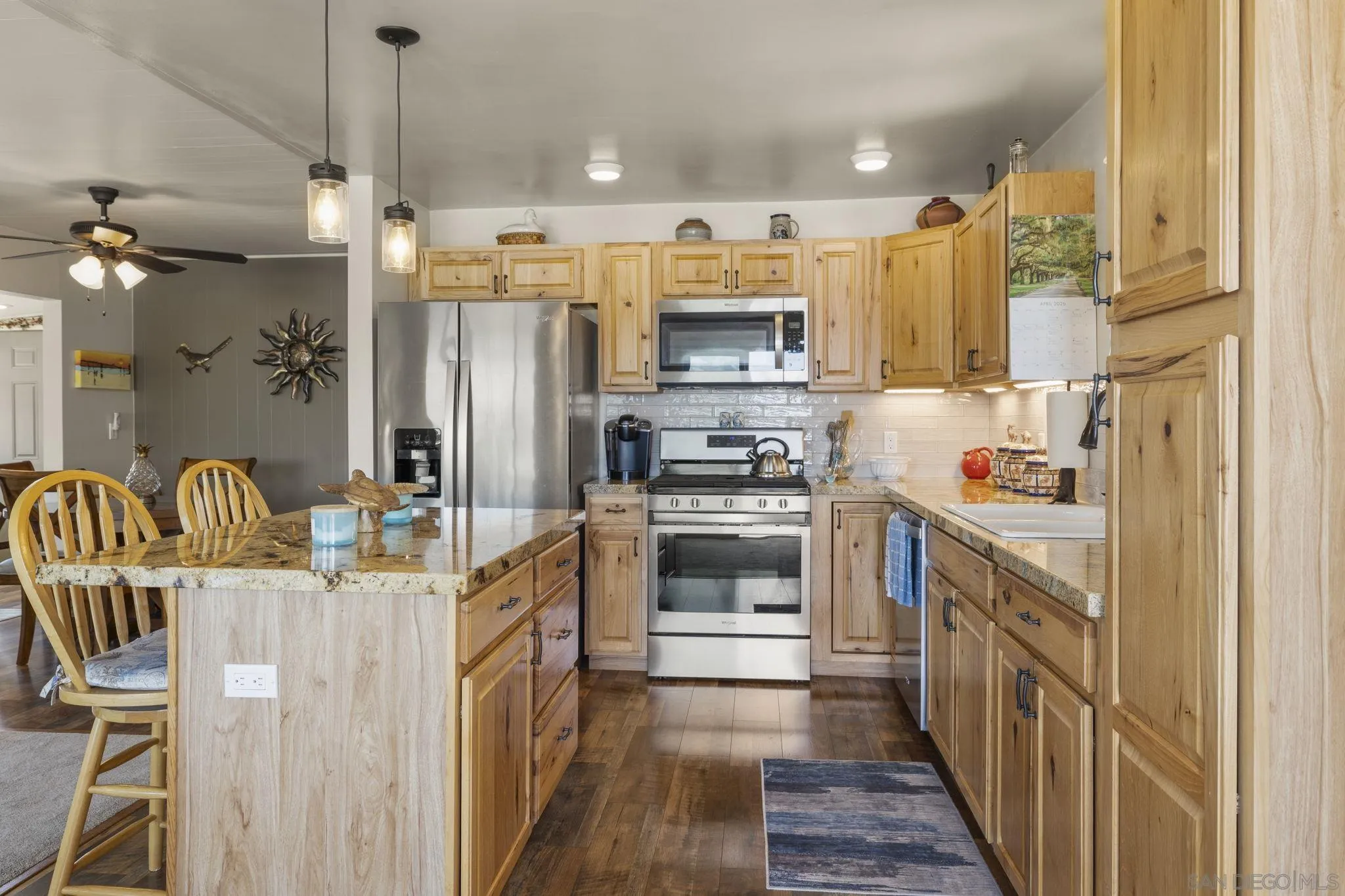 116 Havenview Lane Oceanside, CA 92056 - Photo 3 of 47 a kitchen with stainless steel appliances a stove a sink dishwasher a refrigerator white cabinets and wooden floor
