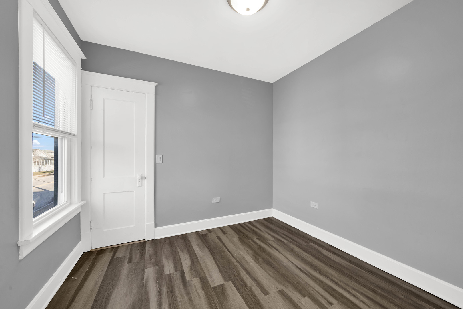 1915 Vermont Street Blue Island, IL 60406 - Photo 11 of 24 a view of an empty room with wooden floor and a window