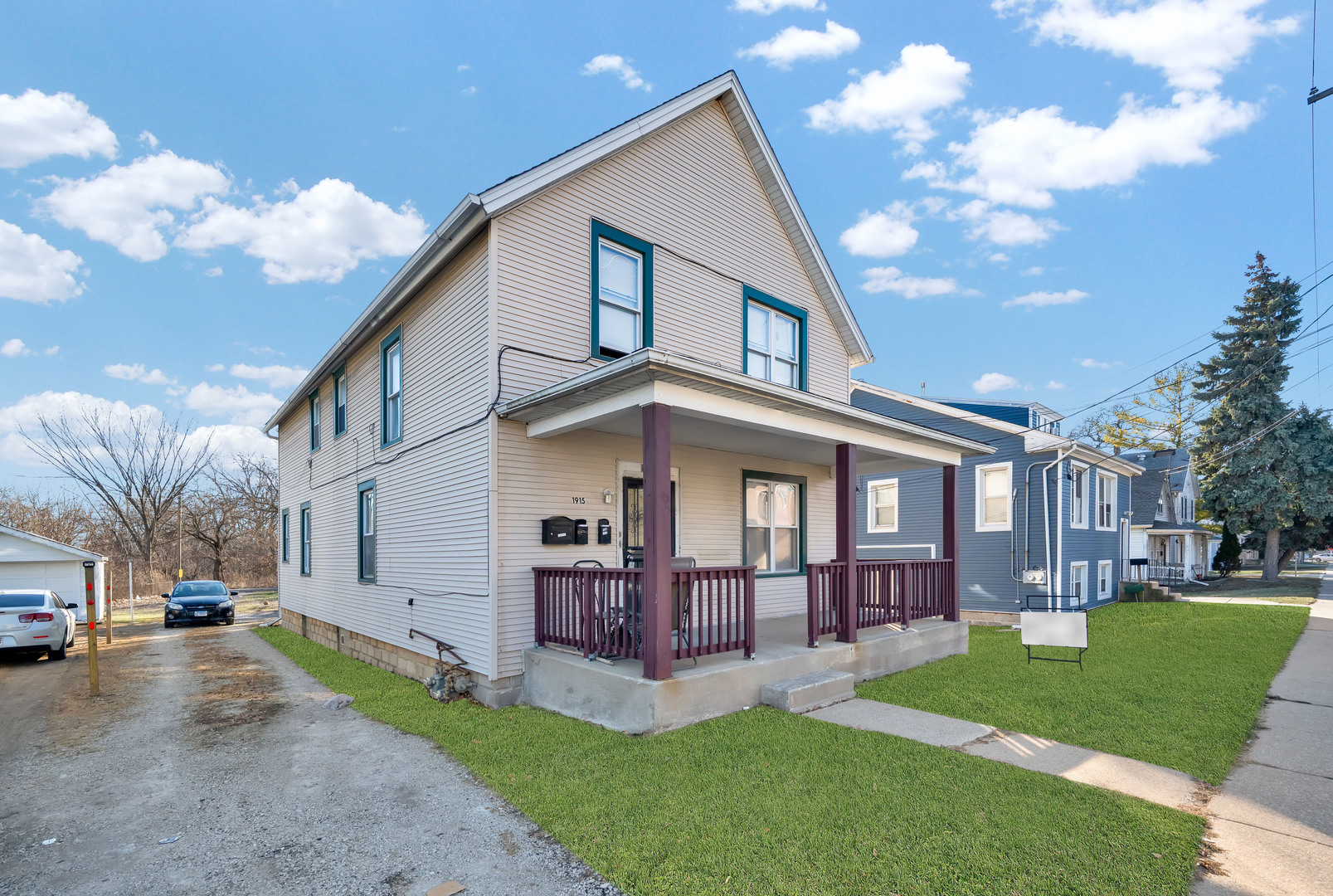 1915 Vermont Street Blue Island, IL 60406 - Photo 21 of 24 a view of a white house next to a yard with big trees
