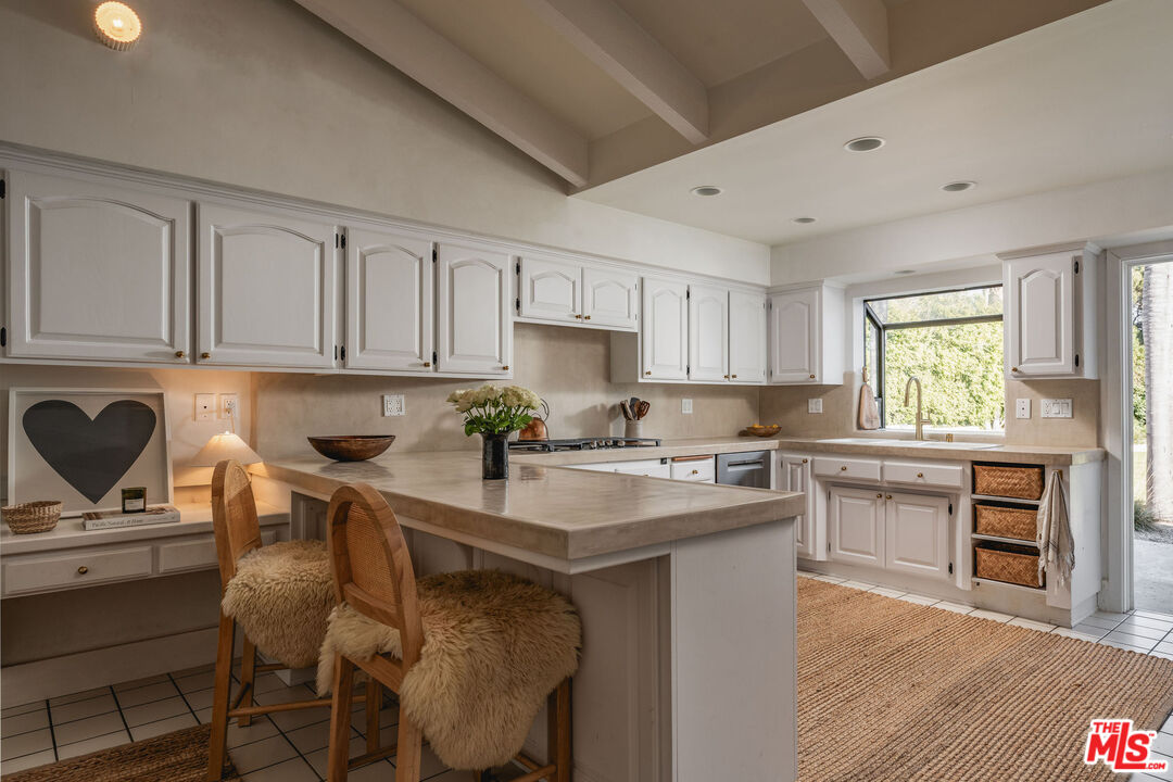 29328 Heathercliff Road Malibu, CA 90265 - Photo 14 of 46 a kitchen with a stove a sink and cabinets