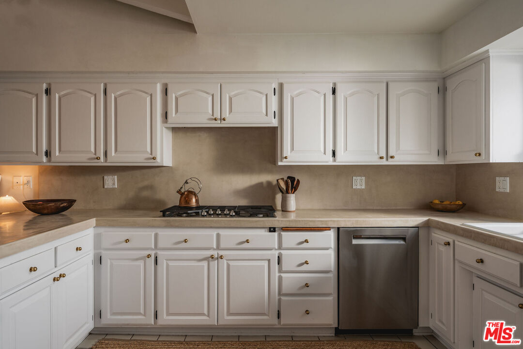 29328 Heathercliff Road Malibu, CA 90265 - Photo 16 of 46 a kitchen with white cabinets and sink