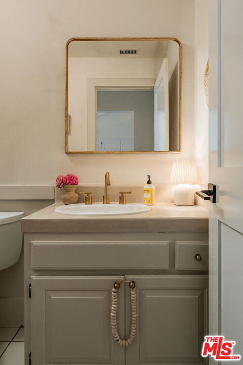 29328 Heathercliff Road Malibu, CA 90265 - Photo 18 of 46 a bathroom with a sink and a mirror
