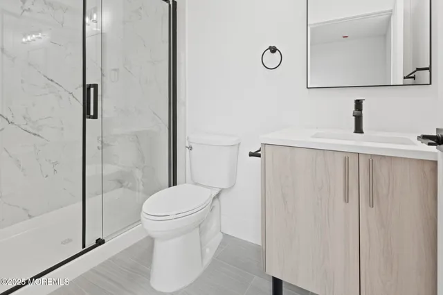 a bathroom with a toilet a sink and shower