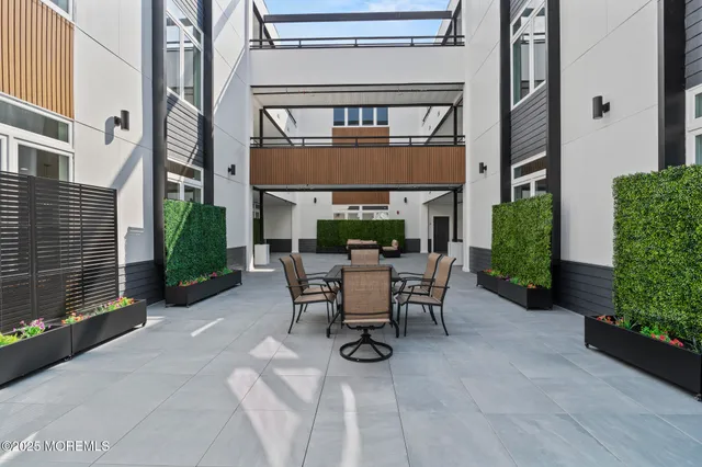 a view of a patio with table and chairs and potted plants