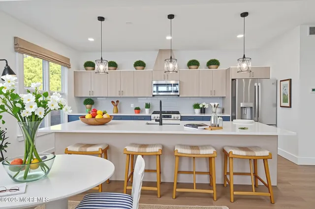 a kitchen with wooden cabinets and stainless steel appliances