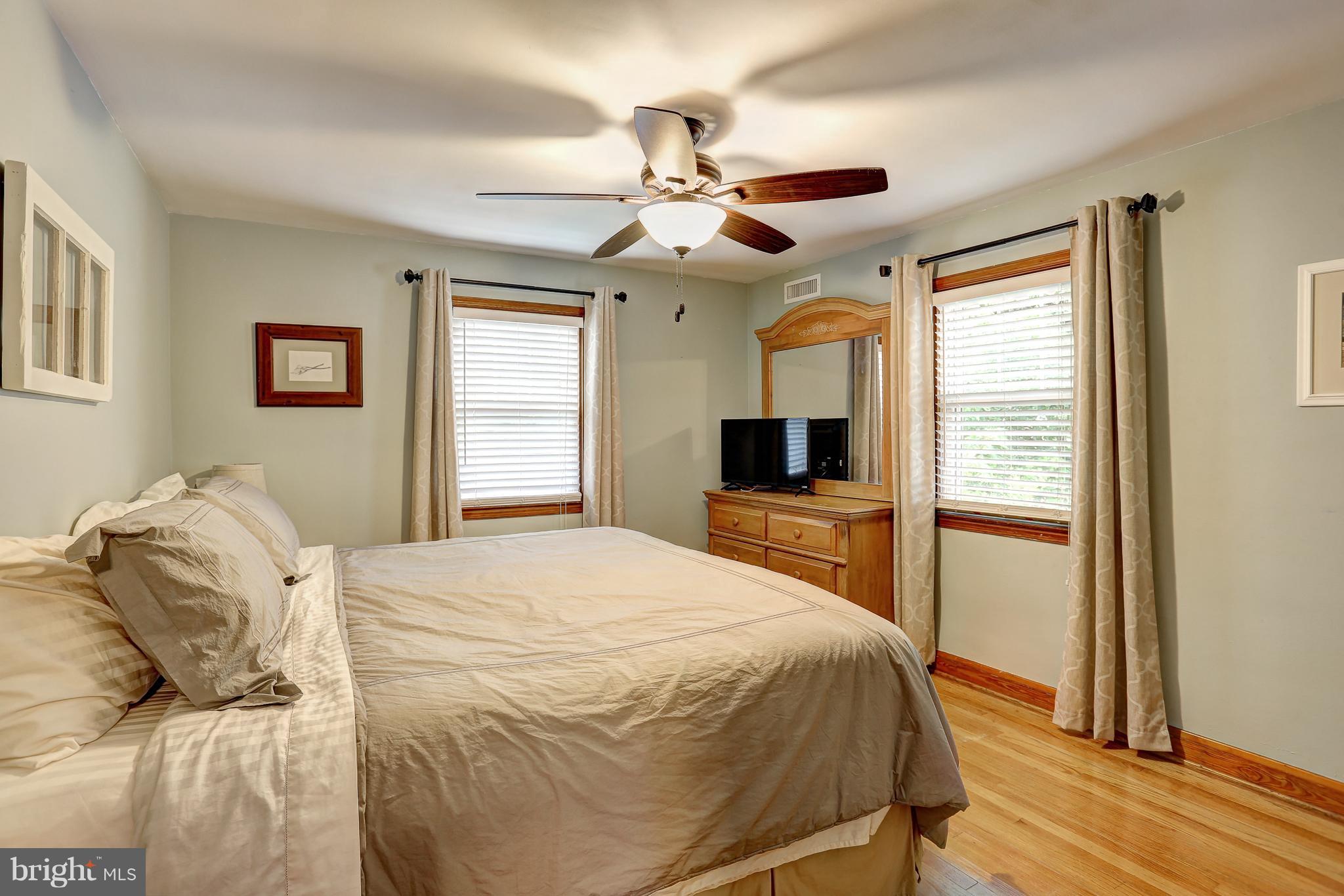 5537 Gayland Road Baltimore, MD 21227 - Photo 14 of 20 a bedroom with a large bed and a window