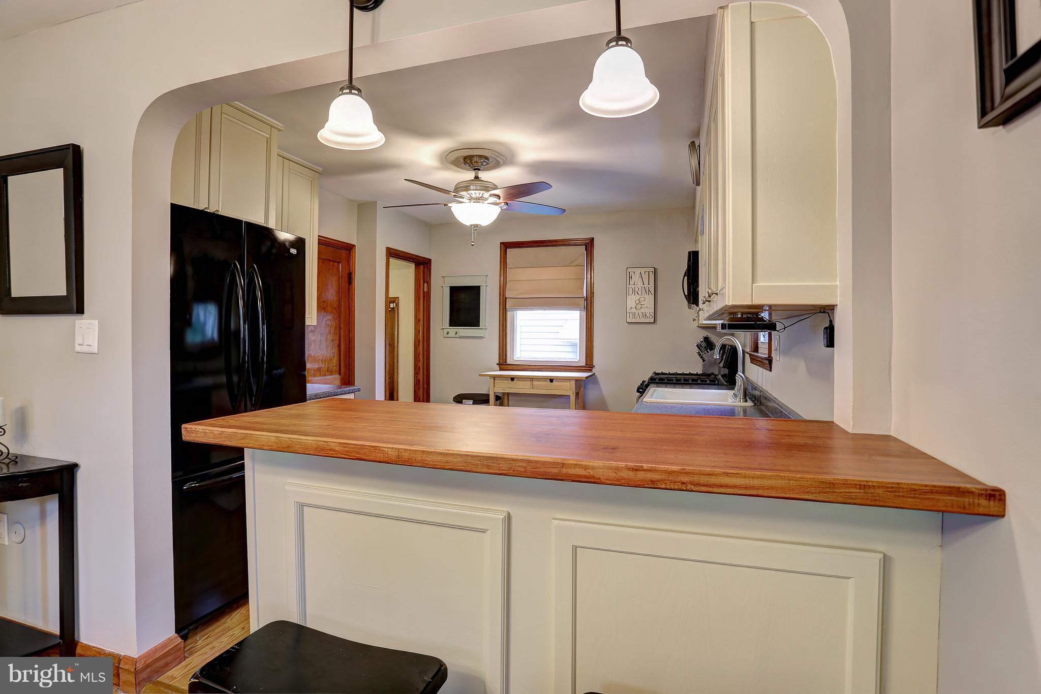 5537 Gayland Road Baltimore, MD 21227 - Photo 5 of 20 a kitchen with cabinets and chandelier
