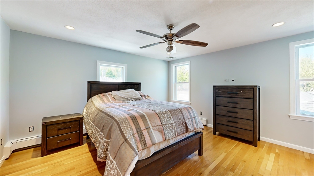 11 Atlantic Avenue Saugus, MA 01906 - Photo 14 of 22 a bedroom with a bed and a chandelier