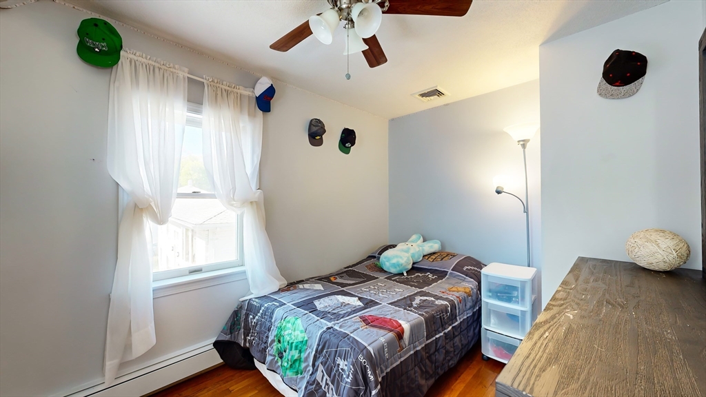 11 Atlantic Avenue Saugus, MA 01906 - Photo 15 of 22 a bedroom with a bed and a window