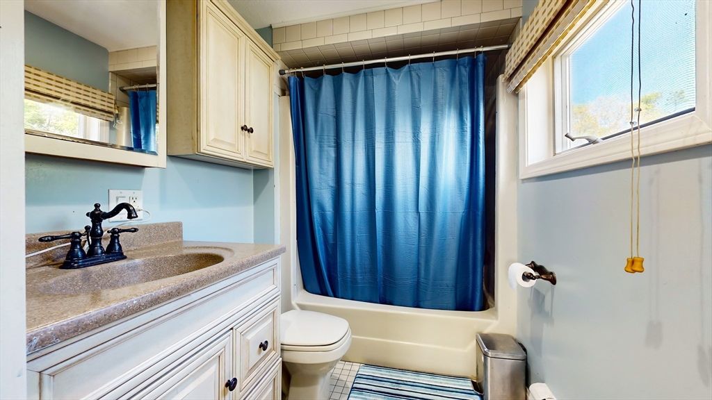 11 Atlantic Avenue Saugus, MA 01906 - Photo 16 of 22 a bathroom with a sink a toilet and bathtub