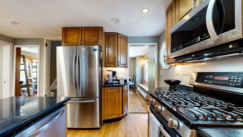 11 Atlantic Avenue Saugus, MA 01906 - Photo 6 of 22 a kitchen with stainless steel appliances granite countertop a refrigerator and a stove top oven