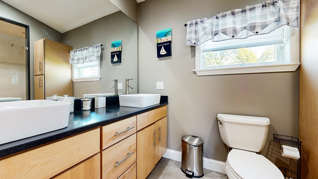 11 Atlantic Avenue Saugus, MA 01906 - Photo 9 of 22 a bathroom with a toilet a sink and a large mirror