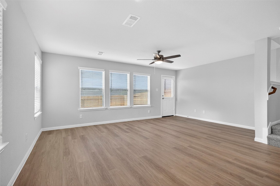 706 Universal Street Navasota, TX 77868 - Photo 11 of 40 a view of an empty room with wooden floor and a window