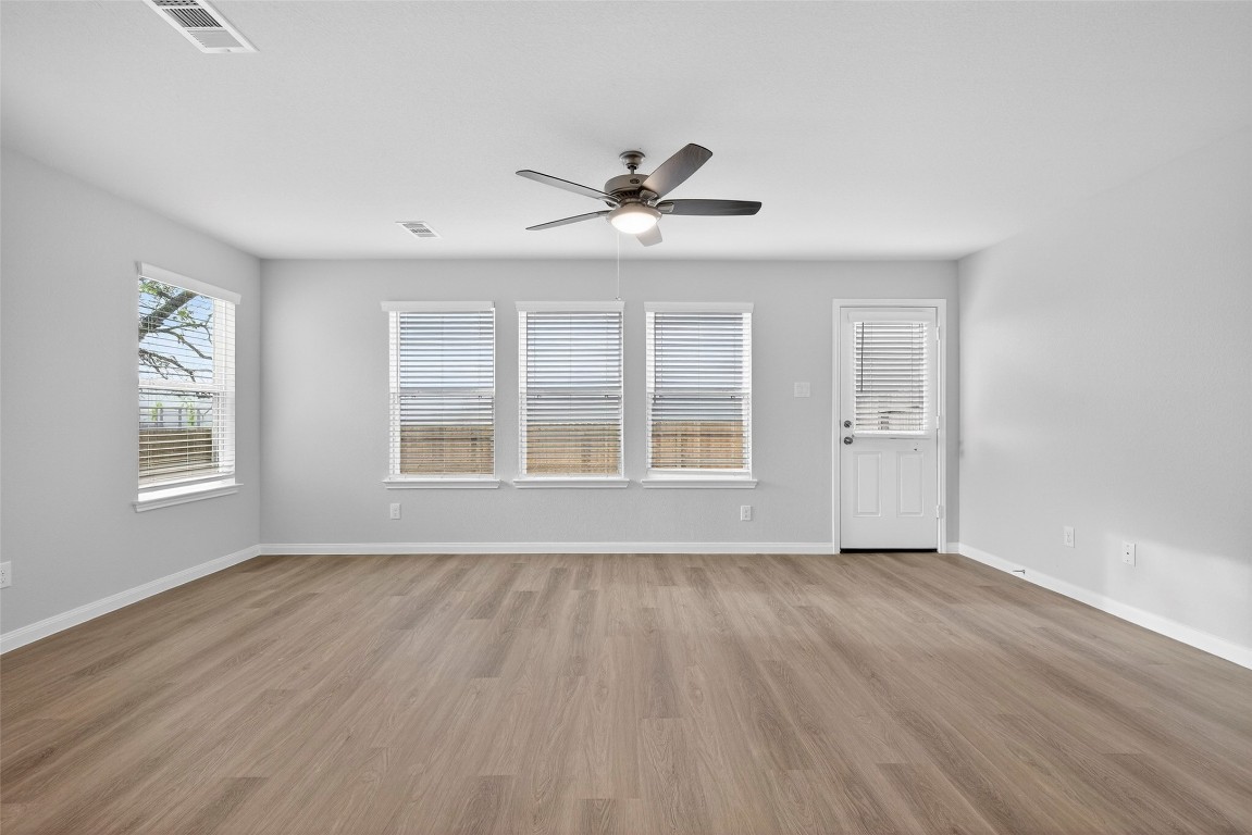 706 Universal Street Navasota, TX 77868 - Photo 12 of 40 a view of an empty room with wooden floor and a window