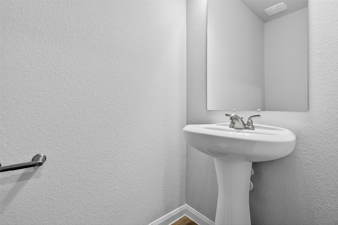 706 Universal Street Navasota, TX 77868 - Photo 15 of 40 a bathroom with a sink a mirror and a toilet