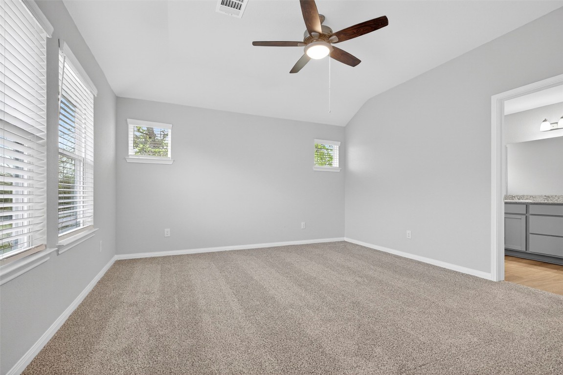 706 Universal Street Navasota, TX 77868 - Photo 17 of 40 an empty room with windows and fan