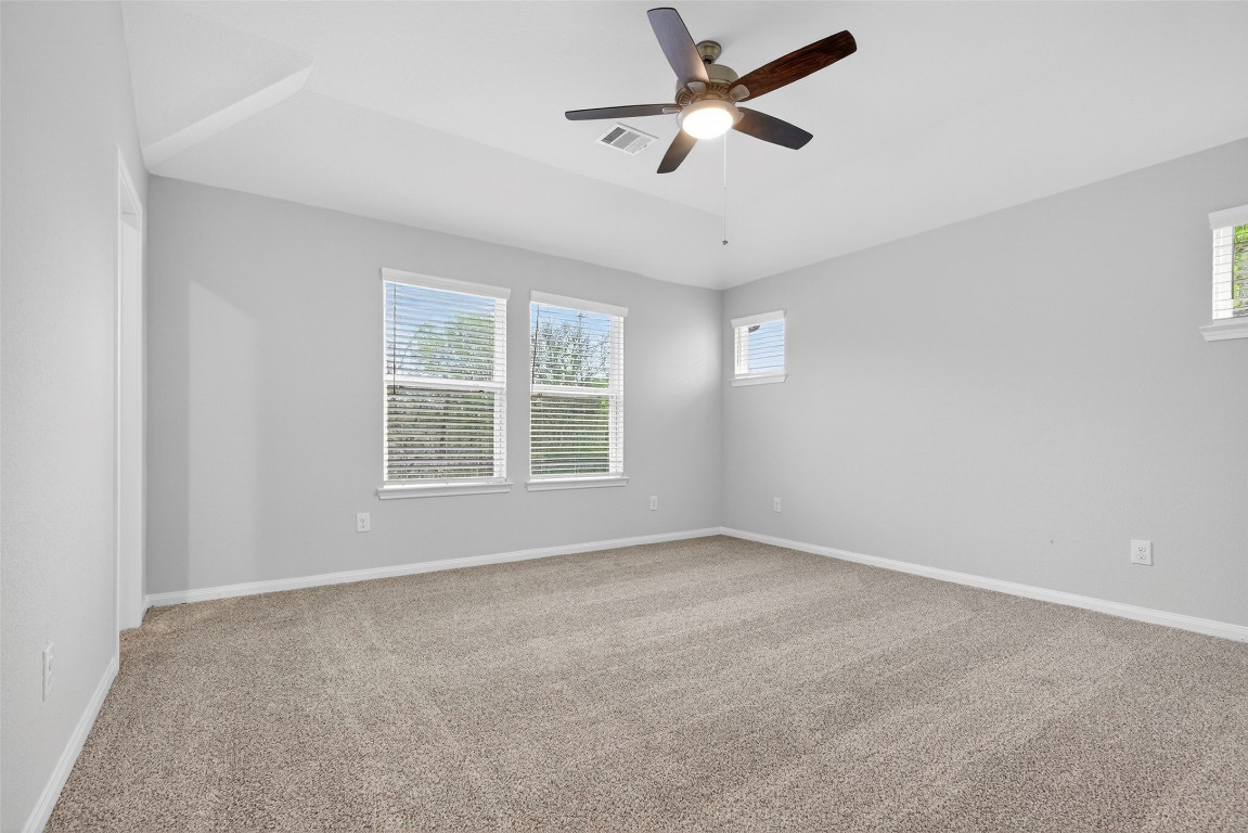 706 Universal Street Navasota, TX 77868 - Photo 18 of 40 an empty room with a window and a fan