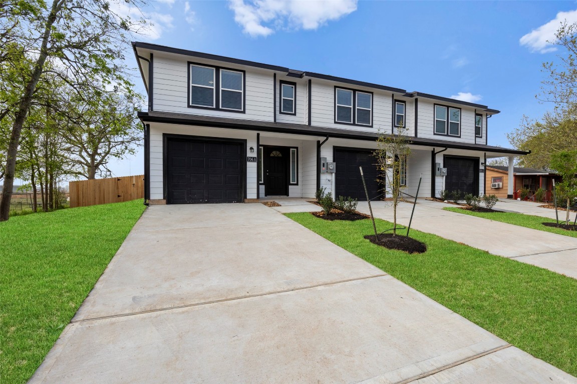 706 Universal Street Navasota, TX 77868 - Photo 2 of 40 a front view of a house with a yard and potted plants
