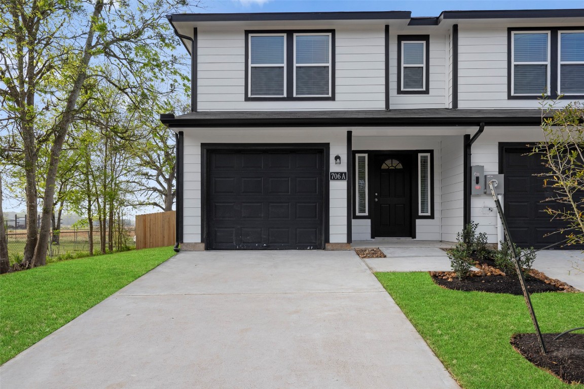 706 Universal Street Navasota, TX 77868 - Photo 29 of 40 a front view of a house with a yard and garage