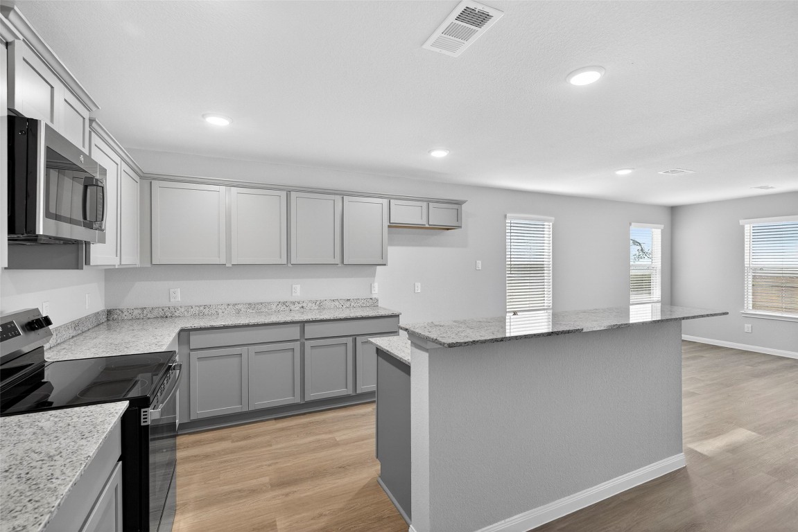 706 Universal Street Navasota, TX 77868 - Photo 6 of 40 a kitchen with granite countertop a sink and cabinets