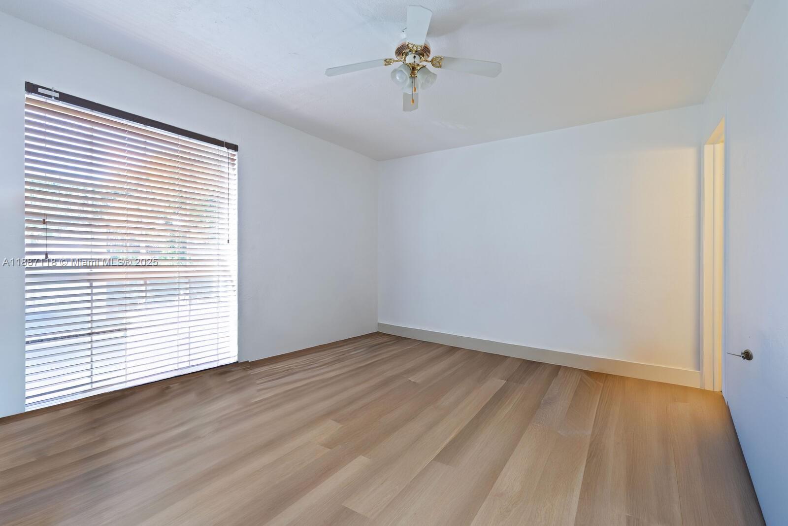 10816 North Kendall Drive, Unit R16 Miami, FL 33176 - Photo 5 of 12 wooden floor in an empty room with a window