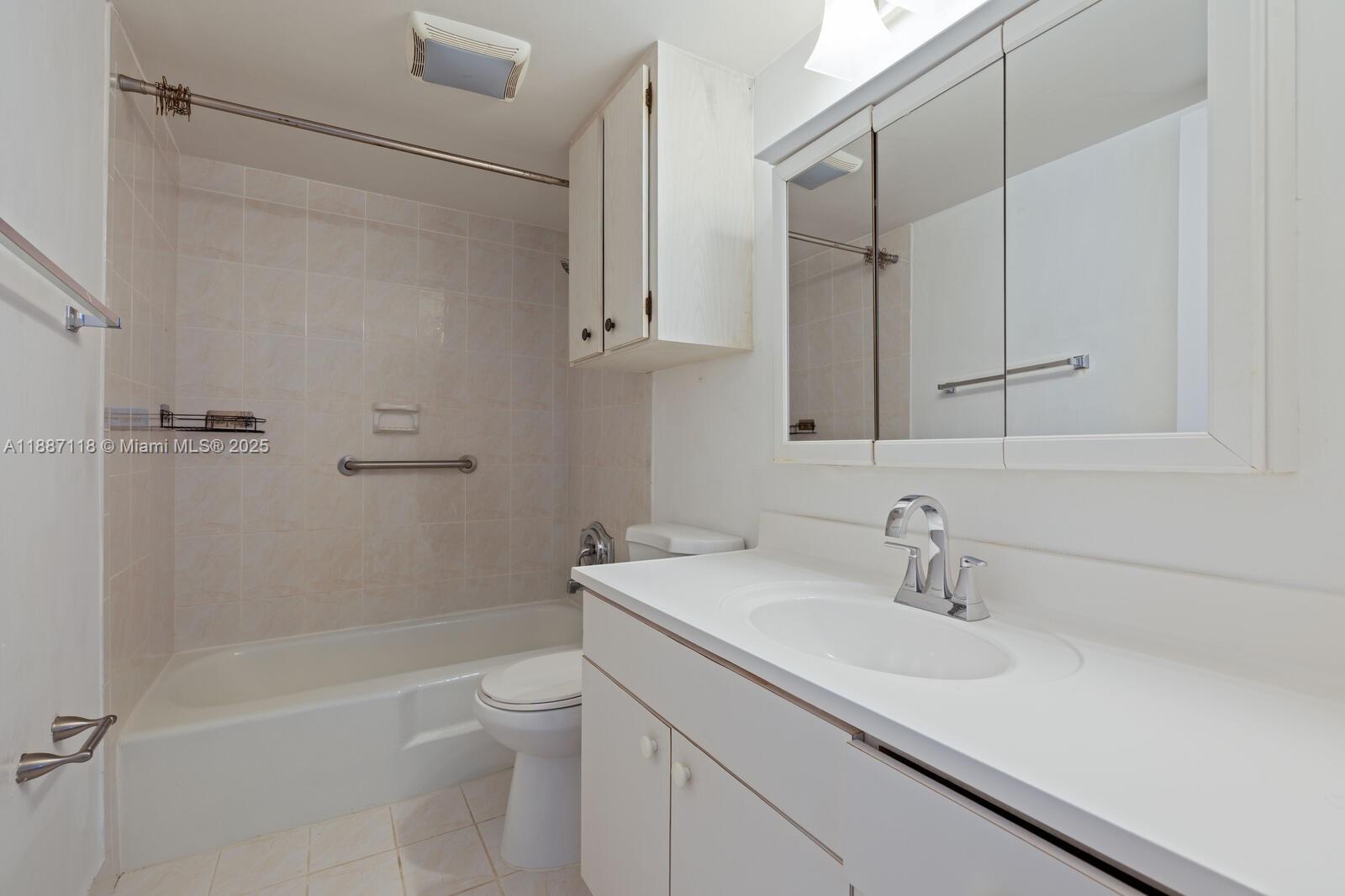 10816 North Kendall Drive, Unit R16 Miami, FL 33176 - Photo 7 of 12 a bathroom with a sink a toilet and shower