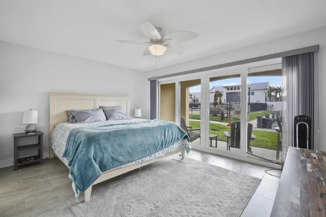 a bedroom with a large bed and a large window