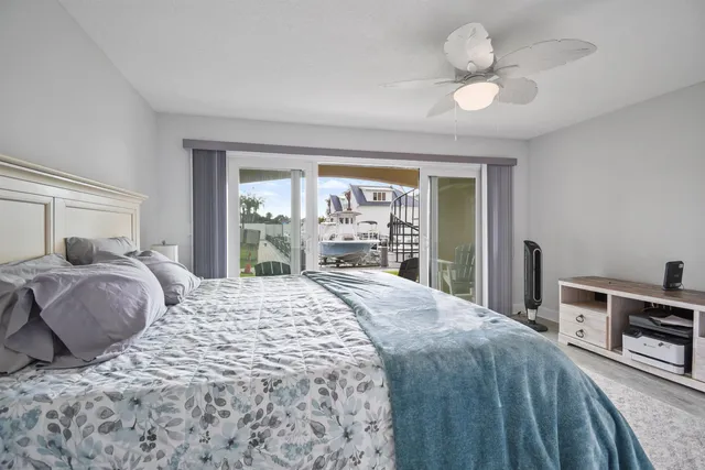 a view of a swimming pool with a chairs and table in a patio