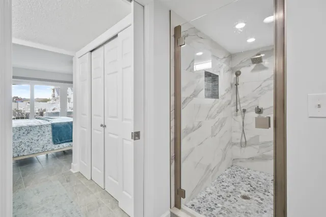 a bedroom with a large bed and a chandelier