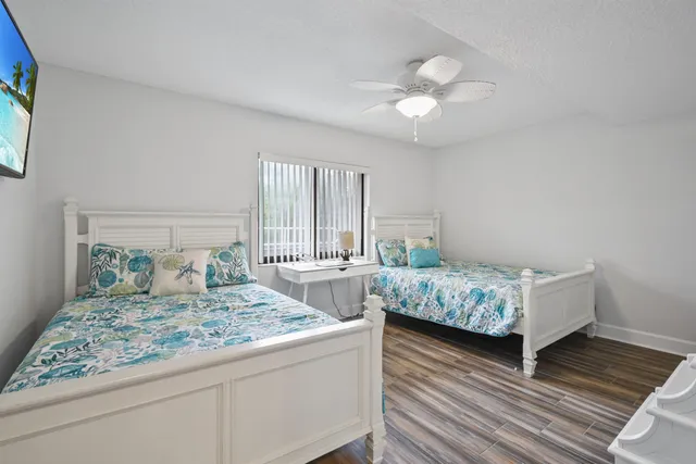 a room with a bed and a wooden floor