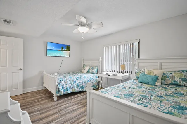 a bathroom with a granite countertop sink a mirror and a toilet