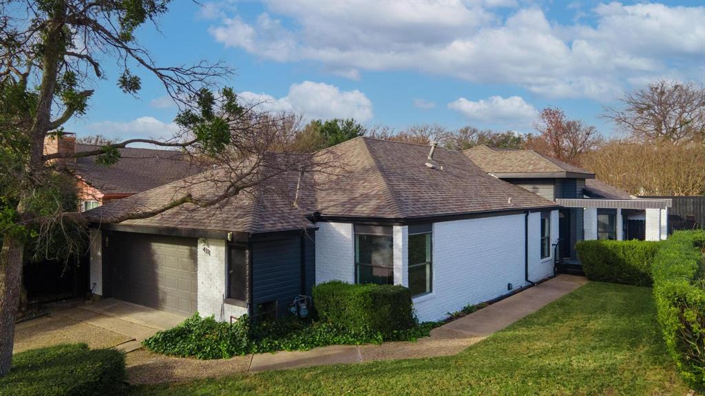 4111 Rush Circle Addison, TX 75001 - Photo 1 of 1 a front view of a house with a garden