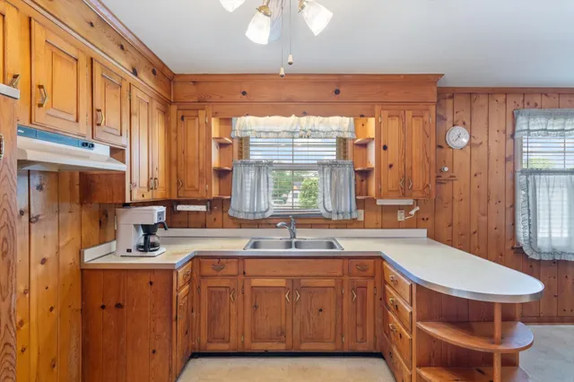 a kitchen with a sink cabinets and window