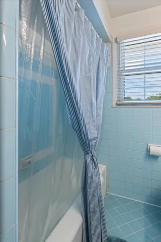 a bathroom with a shower and a sink
