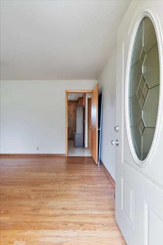 a view of a livingroom with wooden floor and white walls