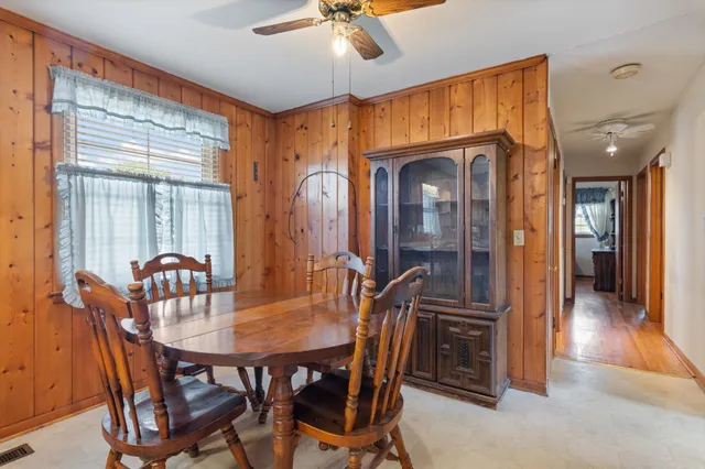 a dining room with furniture and window
