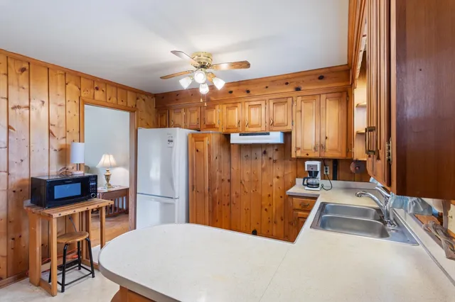 a kitchen with refrigerator cabinets and a table