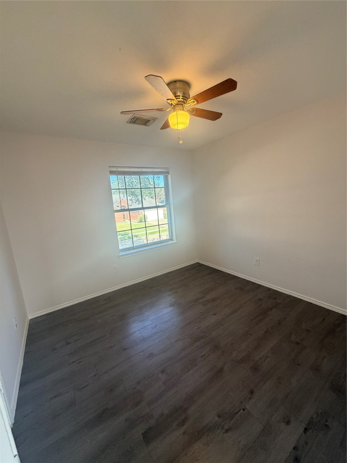 14014 Long Shadow Drive Houston, TX 77015 - Photo 14 of 16 a view of an empty room with wooden floor and a window