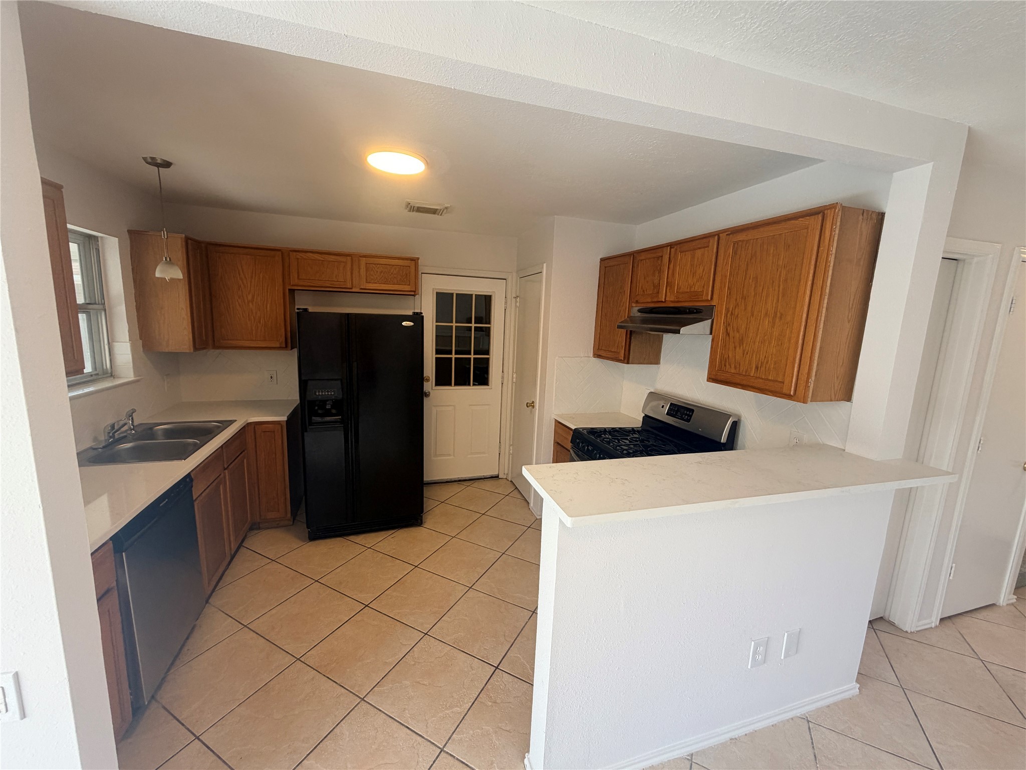 14014 Long Shadow Drive Houston, TX 77015 - Photo 4 of 16 a kitchen with stainless steel appliances a refrigerator sink and cabinets