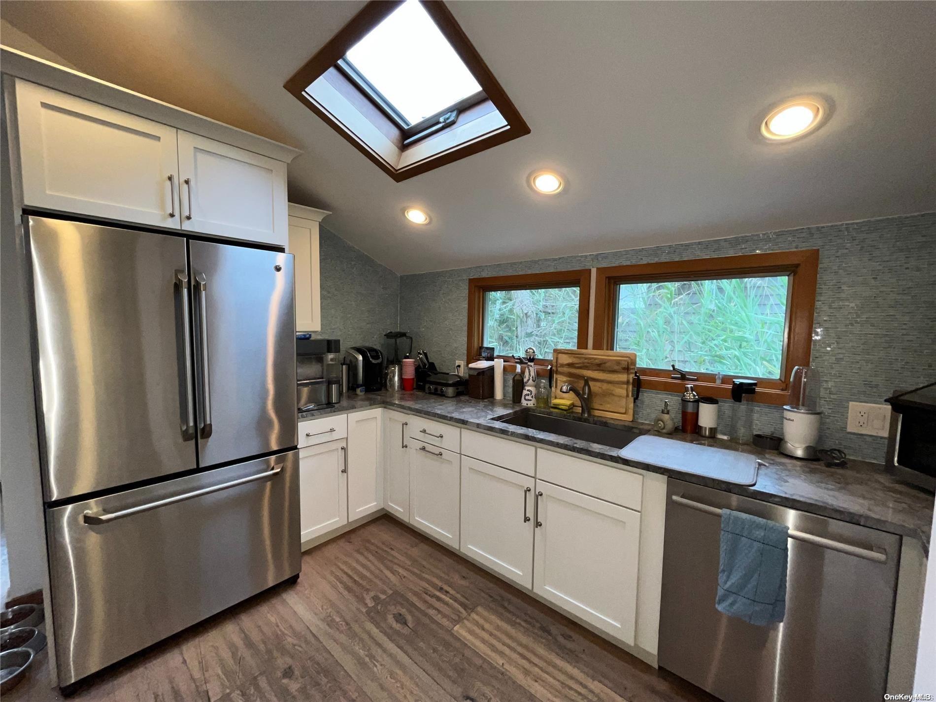 197 Cottage Walk Ocean Beach, NY 11770 - Photo 4 of 21 a kitchen with granite countertop stainless steel appliances a refrigerator microwave and sink