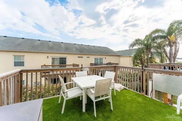 a view of a patio with a table and chairs