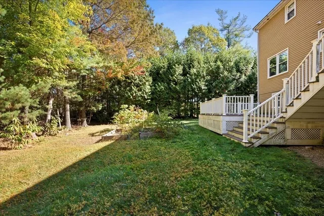 a view of a chair and table in backyard of the house