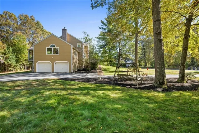 a aerial view of a house with swimming pool and large trees